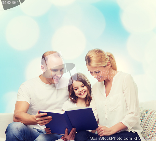 Image of happy family with book at home