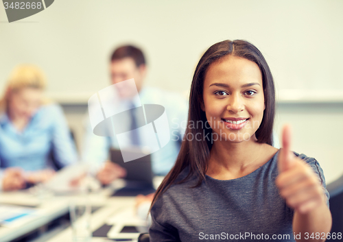 Image of group of smiling businesspeople meeting in office
