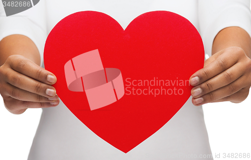 Image of closeup of woman hands with heart