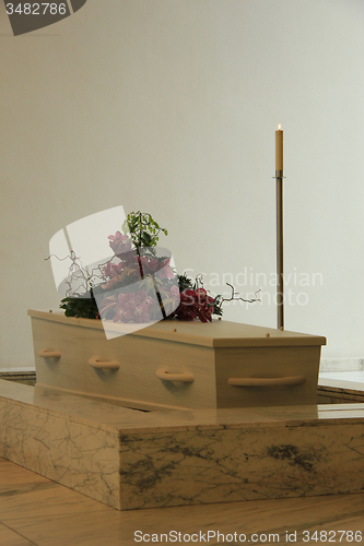 Image of White casket with funeral flowers