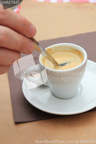 Image of Man stiring an espresso