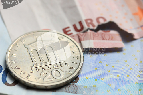 Image of Greek coins on euro notes