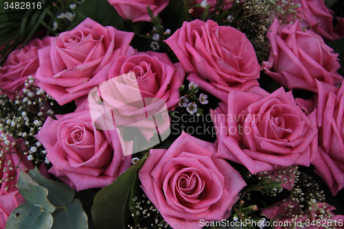 Image of Big pink roses in a bridal bouquet