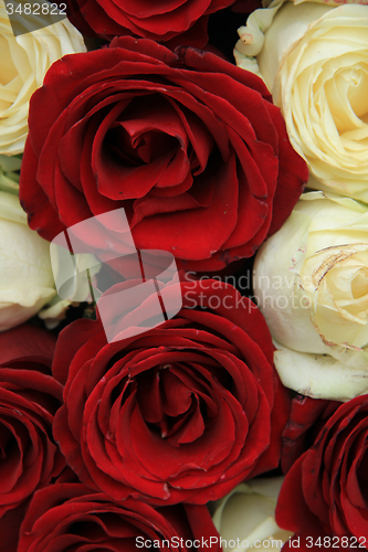 Image of Red and white roses in a wedding arrangement