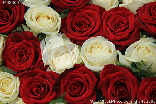 Image of Red and white roses in a wedding arrangement