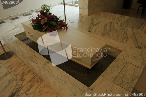 Image of White casket with funeral flowers