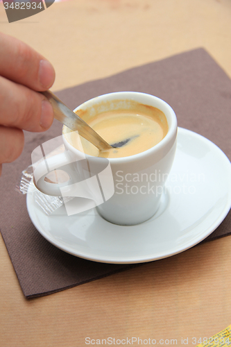 Image of Man stiring an espresso