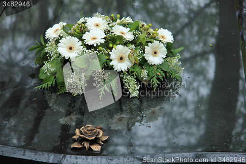 Image of Funeral flowers on a tomb