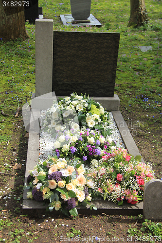 Image of Sympathy flowers on a grave