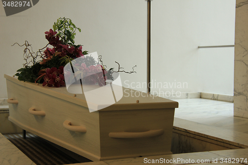 Image of White casket with funeral flowers