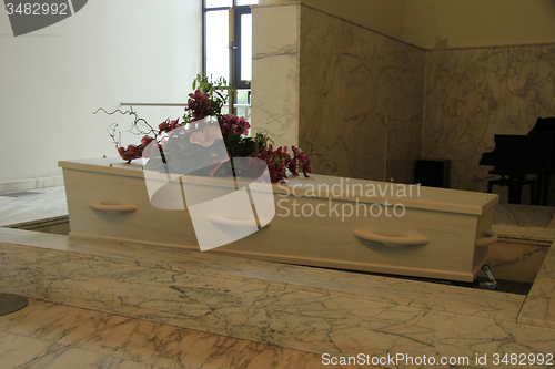 Image of Coffin with funeral flowers