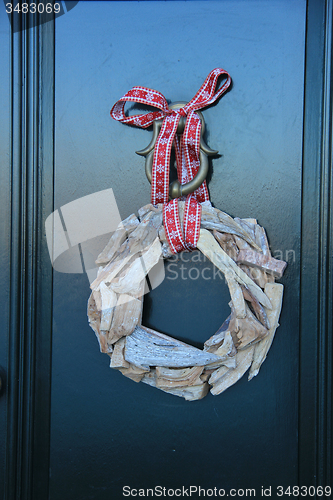 Image of Classic christmas wreath with decorations on a door