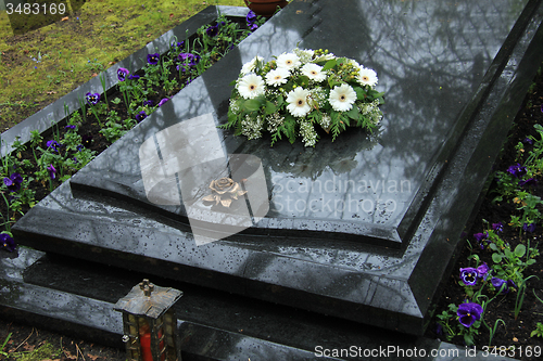 Image of Funeral flowers on a tomb