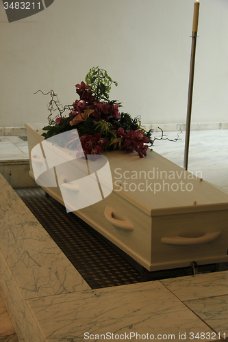 Image of Coffin with funeral flowers