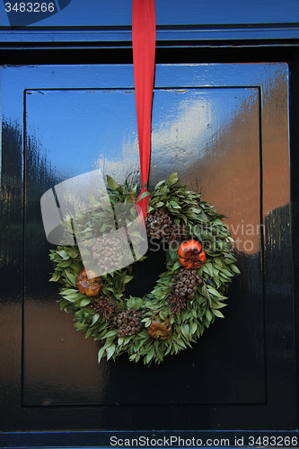 Image of Classic christmas wreath with decorations on a door