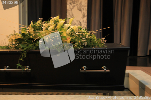 Image of Coffin with funeral flowers