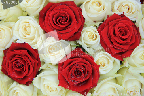 Image of Red and white roses in a wedding arrangement