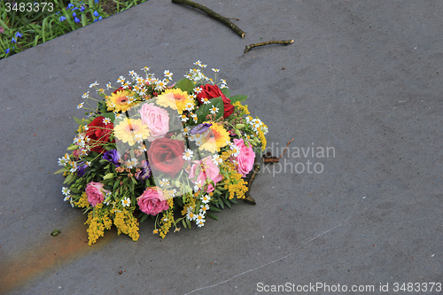 Image of Sympathy flowers on a tombstone