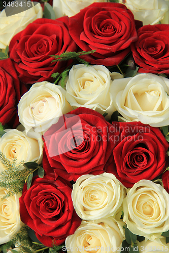 Image of Red and white roses in a wedding arrangement