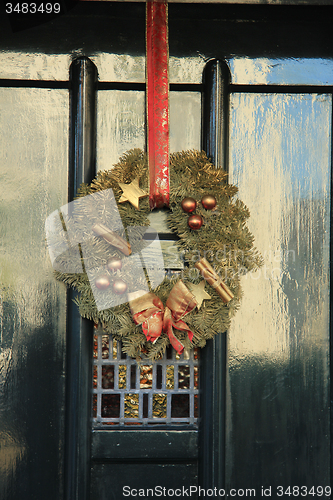 Image of Classic christmas wreath with decorations on a door