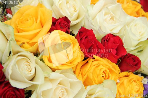 Image of Yellow, white and red roses in a wedding arrangement