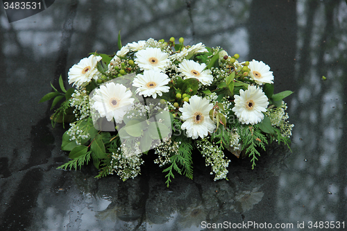 Image of Funeral flowers on a tomb