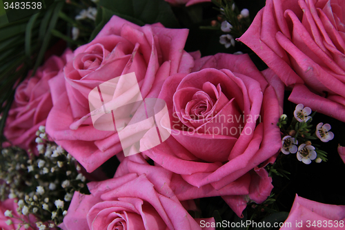 Image of Big pink roses in a bridal bouquet