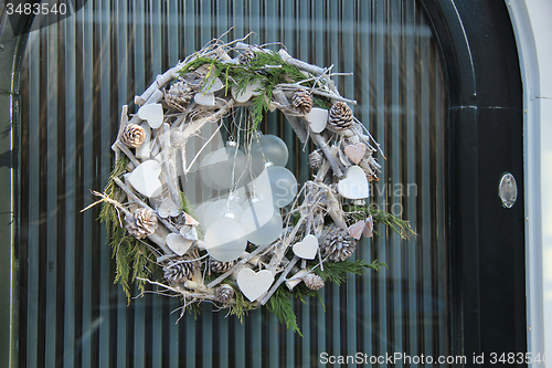 Image of christmas wreath with decorations on a door
