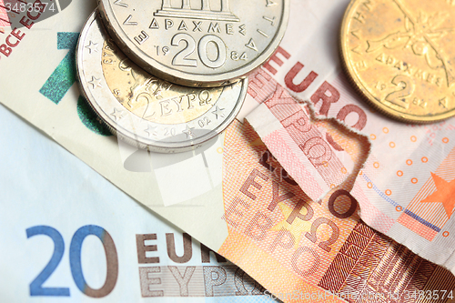 Image of Greek coins on euro notes