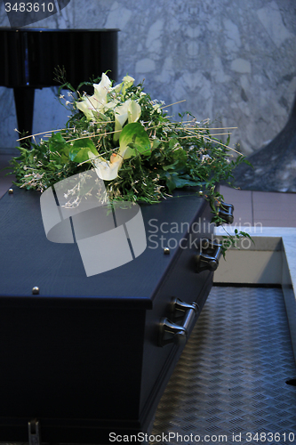 Image of Coffin with funeral flowers