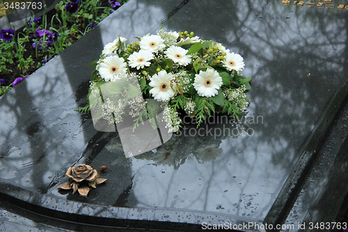 Image of Funeral flowers on a tomb