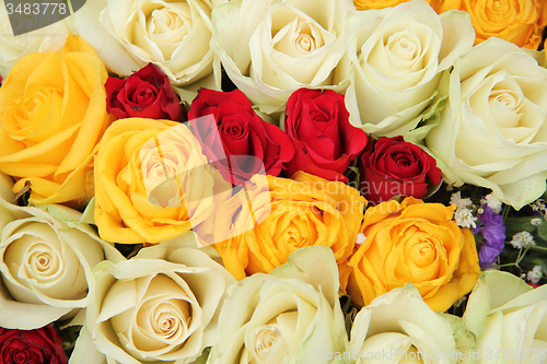 Image of Yellow, white and red roses in a wedding arrangement