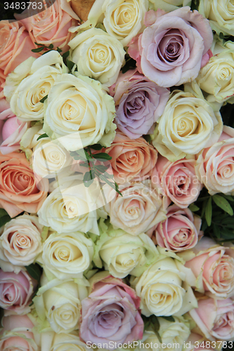 Image of Pastel roses in a wedding arrangement