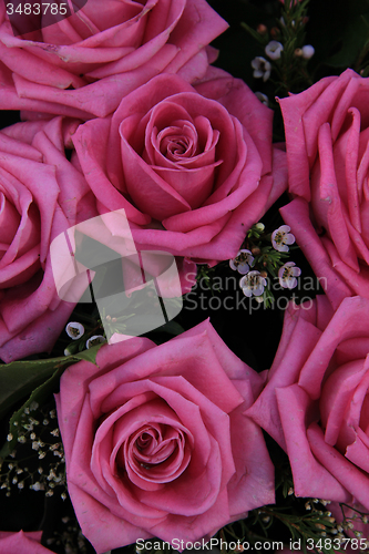 Image of Big pink roses in a bridal bouquet