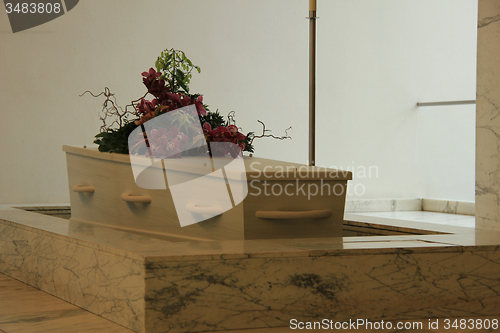 Image of Coffin with funeral flowers