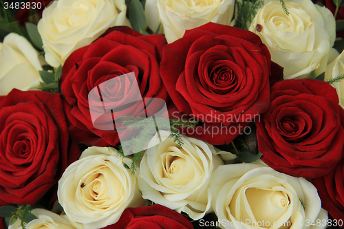 Image of Red and white roses in a wedding arrangement