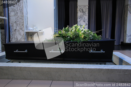 Image of Coffin with funeral flowers