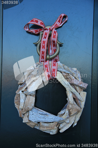 Image of Classic christmas wreath with decorations on a door