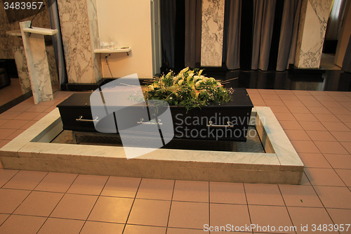 Image of Coffin with funeral flowers