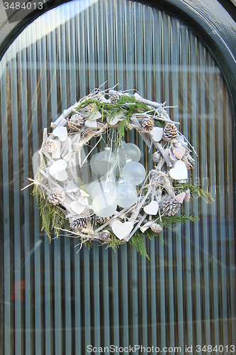 Image of christmas wreath with decorations on a door