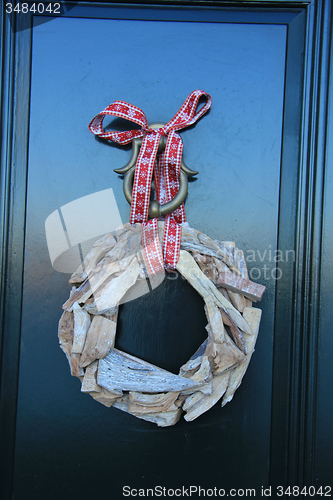 Image of Classic christmas wreath with decorations on a door