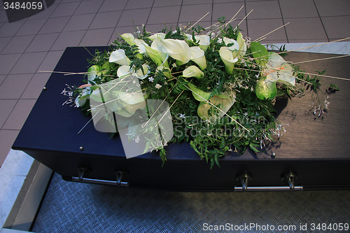 Image of Coffin with funeral flowers