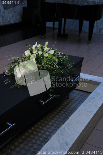 Image of Coffin with funeral flowers