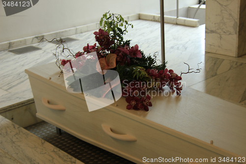 Image of Coffin with funeral flowers