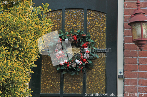 Image of christmas wreath with decorations on a door