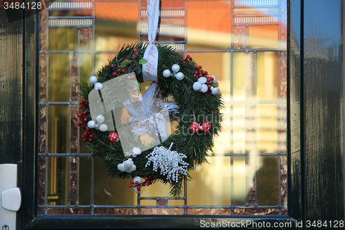 Image of Classic christmas wreath with decorations on a door