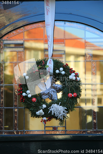 Image of Classic christmas wreath with decorations on a door