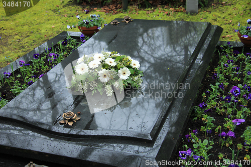 Image of Funeral flowers on a tomb