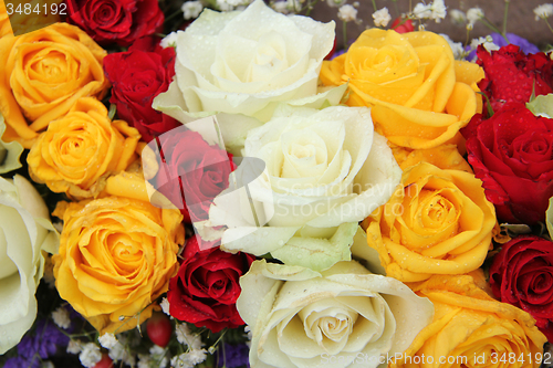 Image of yellow, white and red roses in a wedding arrangement