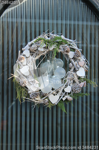 Image of christmas wreath with decorations on a door